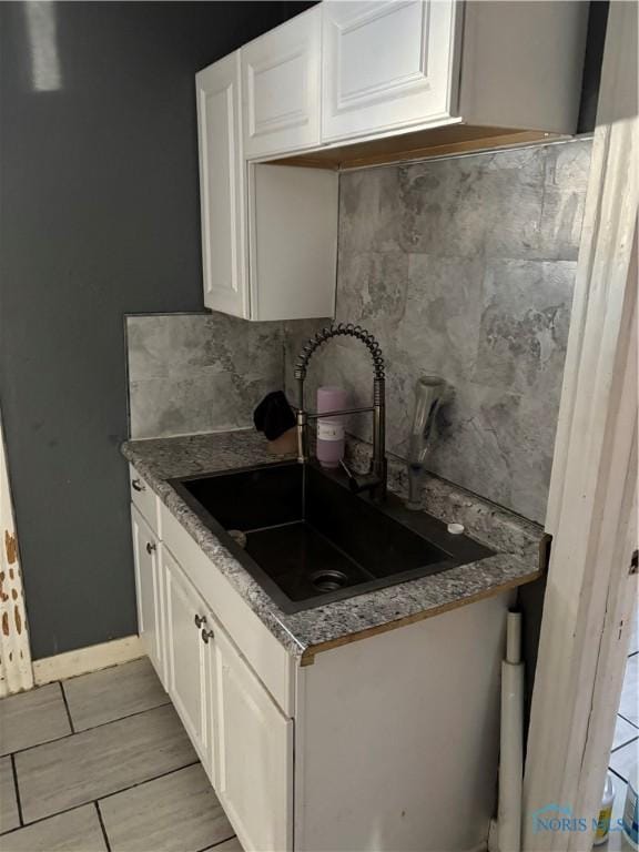 315 Austin St, Toledo, OH 43608 - kitchen featuring white cabinetry and tasteful backsplash