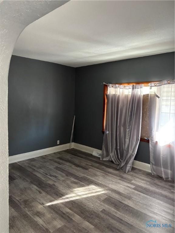 315 Austin St, Toledo, OH 43608 - empty room with wood finished floors and arched walkways