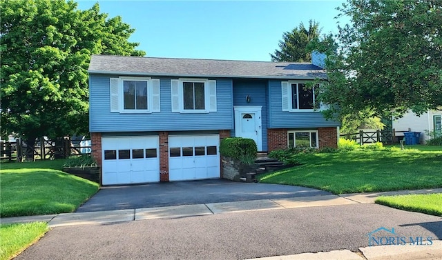 856 Village Pkwy, Waterville, OH 43566 - split foyer home featuring brick siding, a garage, asphalt driveway, and a chimney