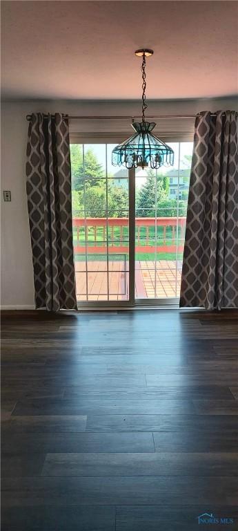 856 Village Pkwy, Waterville, OH 43566 - unfurnished dining area with wood finished floors and a chandelier