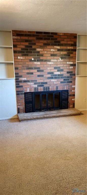 856 Village Pkwy, Waterville, OH 43566 - detailed view of a fireplace, a textured ceiling, and carpet flooring