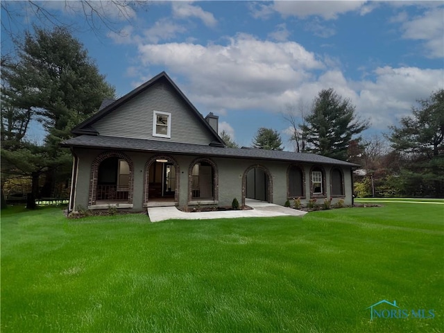 6933 Providence Neapolis Swanton Rd, Swanton, OH 43558 - back of property with a porch, a lawn, and a chimney