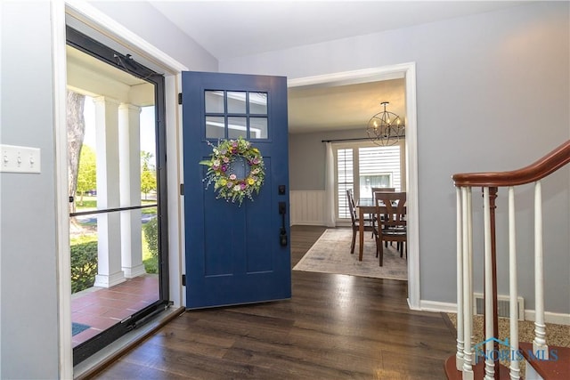 1619 Grant Blvd, Findlay, OH 45840 - entryway with dark wood-type flooring, a chandelier, a wainscoted wall, and stairs