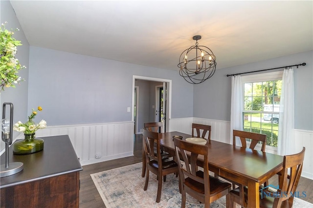 1619 Grant Blvd, Findlay, OH 45840 - dining space with dark wood finished floors, a wainscoted wall, and a chandelier