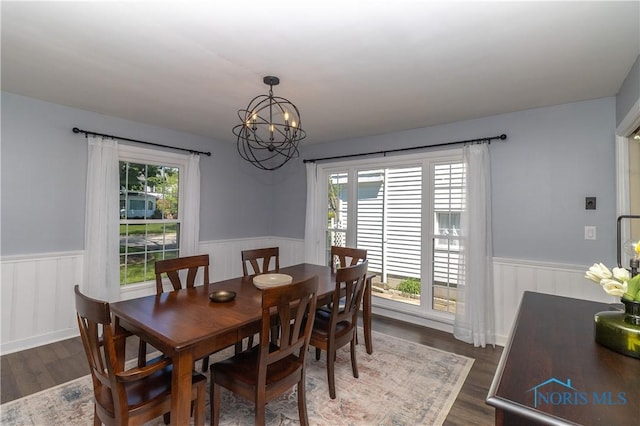 1619 Grant Blvd, Findlay, OH 45840 - dining room with a wainscoted wall, a chandelier, healthy amount of natural light, and dark wood-style floors