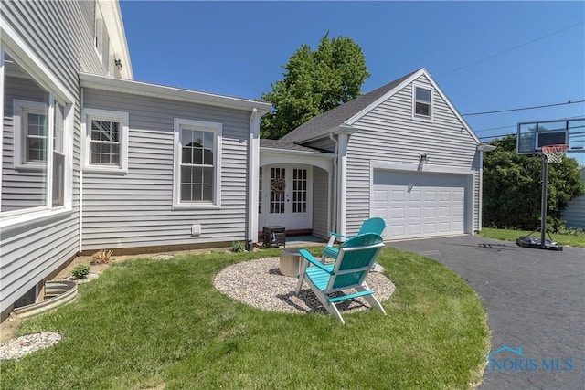1619 Grant Blvd, Findlay, OH 45840 - view of front of property with a front yard, asphalt driveway, french doors, and a garage