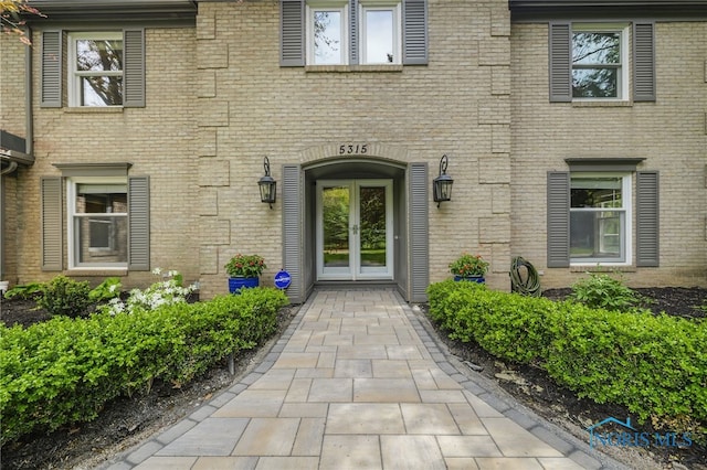 doorway to property with french doors and brick siding