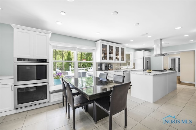 dining room with light tile patterned floors and recessed lighting