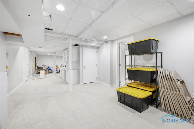 finished basement with carpet flooring, a paneled ceiling, recessed lighting, and baseboards
