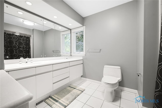 bathroom with toilet, recessed lighting, baseboards, double vanity, and tile patterned flooring