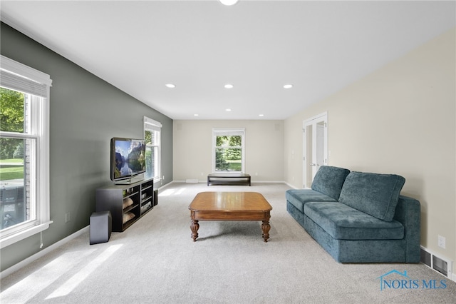 carpeted living room with recessed lighting, baseboards, and french doors