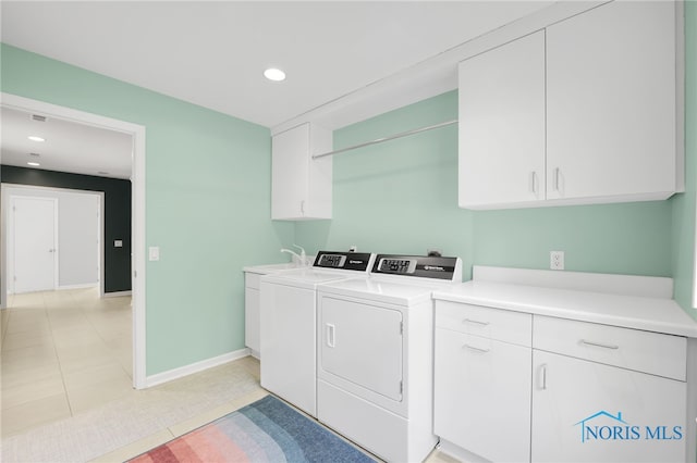 washroom with cabinet space, washer and dryer, baseboards, recessed lighting, and light tile patterned floors