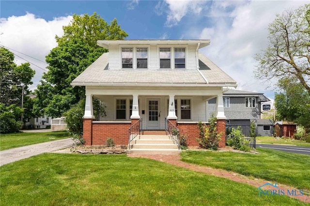 210 Lima Ave, Findlay, OH 45840 - view of front of house with a front lawn, covered porch, and brick siding