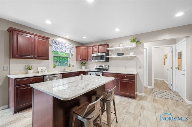 312 Fairmont Dr, Findlay, OH 45840 - kitchen with stainless steel appliances, open shelves, a sink, a kitchen island, and tasteful backsplash