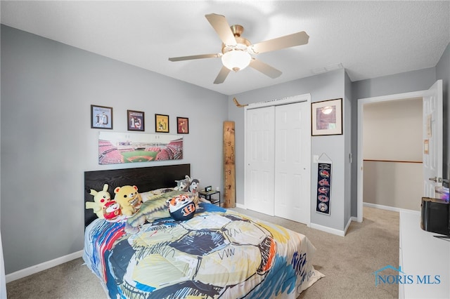 312 Fairmont Dr, Findlay, OH 45840 - bedroom with a closet, light carpet, baseboards, and ceiling fan