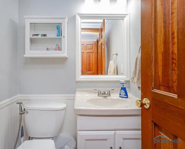 3757 N Mccord Rd, Toledo, OH 43617 - half bath with toilet, a wainscoted wall, and vanity