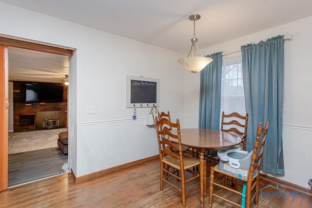 3757 N Mccord Rd, Toledo, OH 43617 - dining area with wood finished floors, wainscoting, ceiling fan, and wooden walls