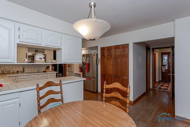 3757 N Mccord Rd, Toledo, OH 43617 - dining room with dark wood-style floors and baseboards