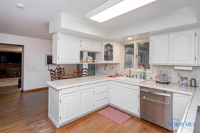 3757 N Mccord Rd, Toledo, OH 43617 - kitchen with stainless steel dishwasher, a sink, tile countertops, and a peninsula