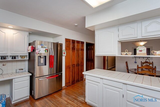 3757 N Mccord Rd, Toledo, OH 43617 - kitchen with stainless steel fridge with ice dispenser, tile countertops, white cabinets, and dark wood-style flooring