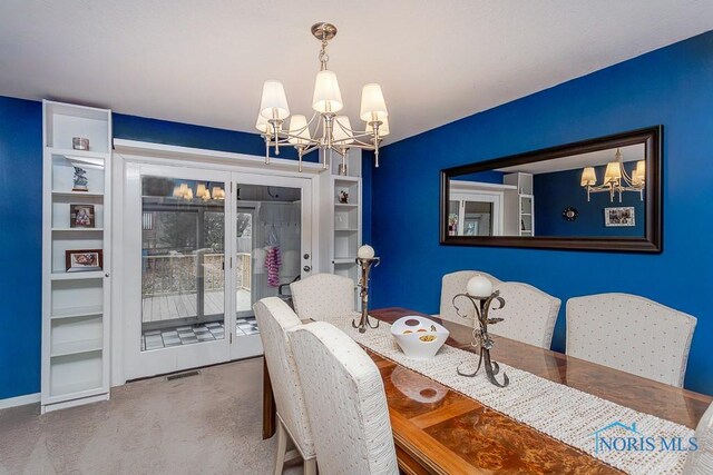 3757 N Mccord Rd, Toledo, OH 43617 - dining room with a chandelier, built in shelves, baseboards, and finished concrete flooring