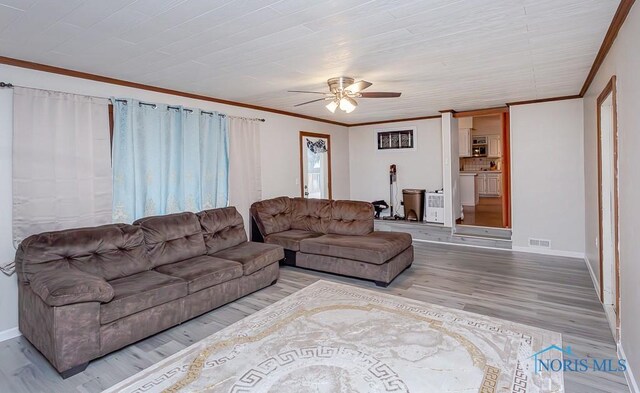 3757 N Mccord Rd, Toledo, OH 43617 - living area with ceiling fan, crown molding, baseboards, and wood finished floors