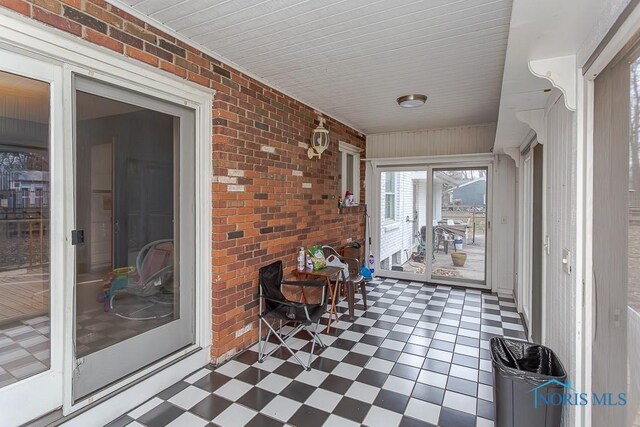 3757 N Mccord Rd, Toledo, OH 43617 - sunroom with brick wall and tile patterned floors