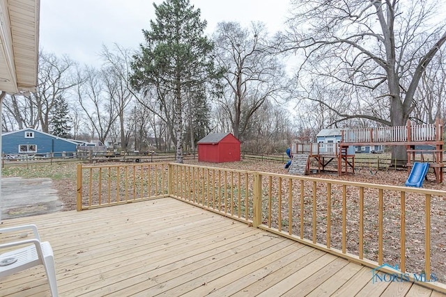 3757 N Mccord Rd, Toledo, OH 43617 - deck featuring a playground, a storage shed, a fenced backyard, and an outdoor structure