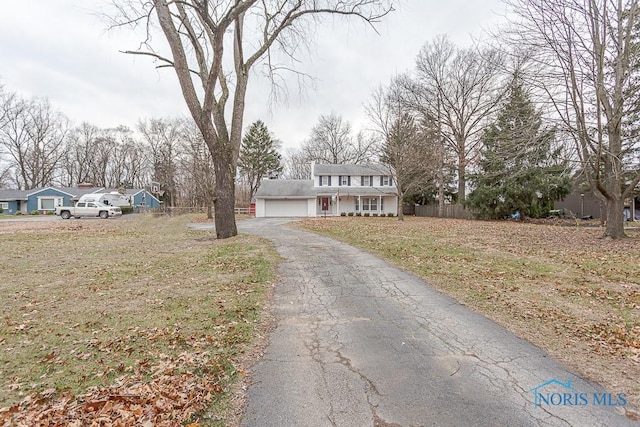 3757 N Mccord Rd, Toledo, OH 43617 - traditional home with asphalt driveway and an attached garage