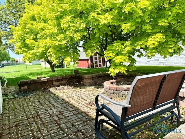 360 N Harmony Dr, Napoleon, OH 43545 - view of patio with an outdoor fire pit and an outbuilding