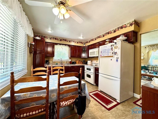360 N Harmony Dr, Napoleon, OH 43545 - kitchen with white appliances, a ceiling fan, light countertops, a sink, and light flooring