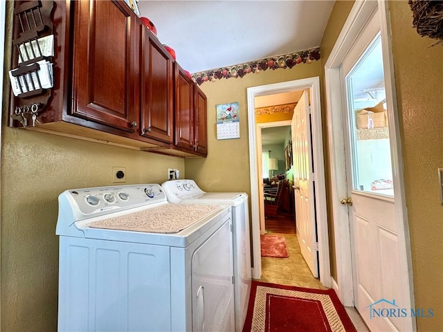 360 N Harmony Dr, Napoleon, OH 43545 - laundry area featuring independent washer and dryer, cabinet space, and a textured wall