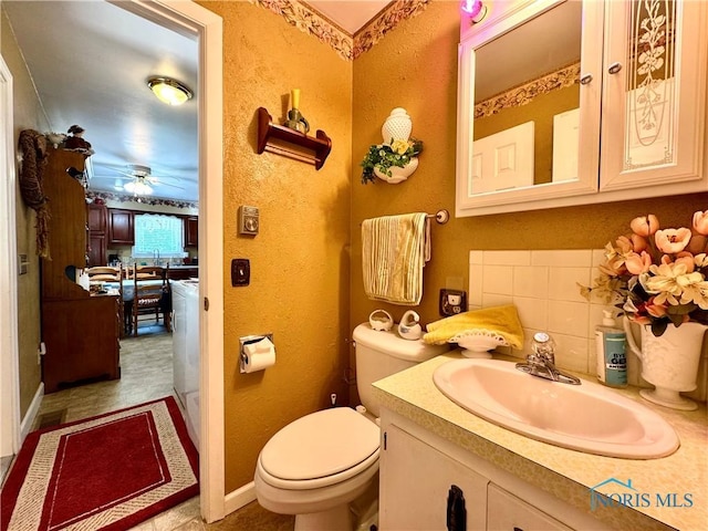 360 N Harmony Dr, Napoleon, OH 43545 - half bathroom with ceiling fan, toilet, vanity, and a textured wall