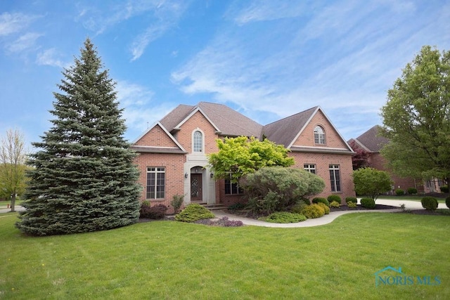 665 Meadowview Dr, Findlay, OH 45840 - view of front of home with brick siding and a front yard