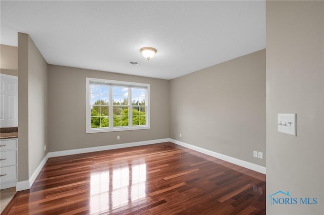 665 Meadowview Dr, Findlay, OH 45840 - spare room with wood finished floors and baseboards