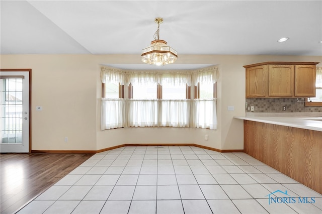 1330 Kennsington Dr, Findlay, OH 45840 - unfurnished dining area with plenty of natural light, a chandelier, baseboards, light wood-style floors, and recessed lighting