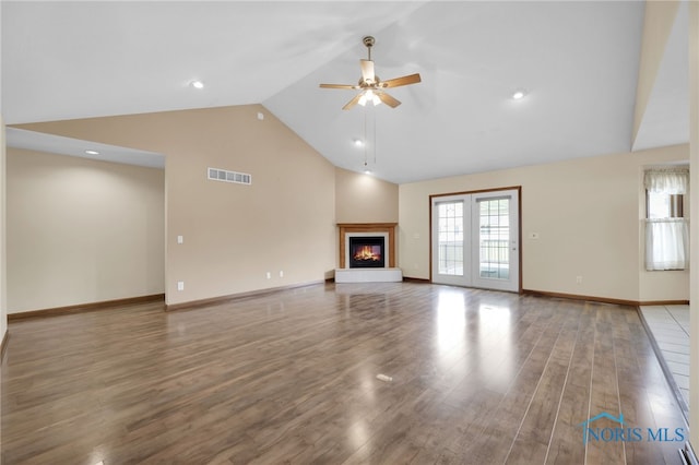 1330 Kennsington Dr, Findlay, OH 45840 - unfurnished living room featuring a ceiling fan, high vaulted ceiling, wood finished floors, a glass covered fireplace, and baseboards