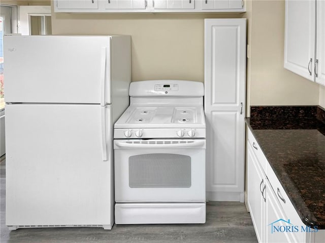 1381 Junior Dr, Maumee, OH 43537 - kitchen featuring white appliances, wood finished floors, white cabinets, and dark stone countertops