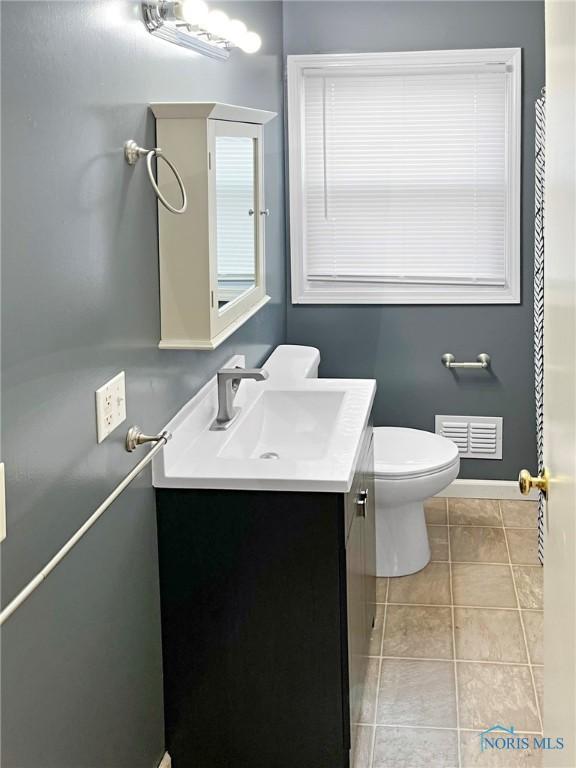 1381 Junior Dr, Maumee, OH 43537 - bathroom featuring vanity, baseboards, toilet, and tile patterned floors