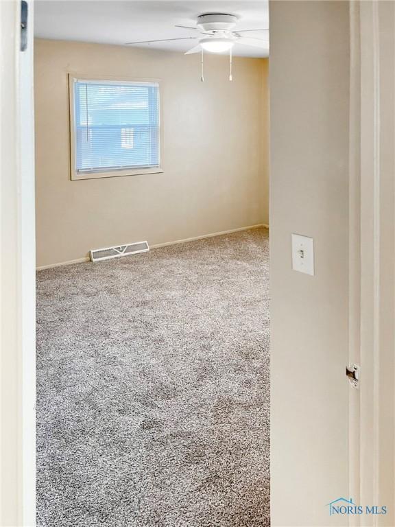 1381 Junior Dr, Maumee, OH 43537 - empty room with a ceiling fan, baseboards, and carpet