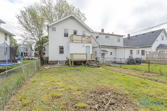 940 Kingston Ave, Toledo, OH 43605 - back of house with a trampoline, a balcony, a wooden deck, and a chimney