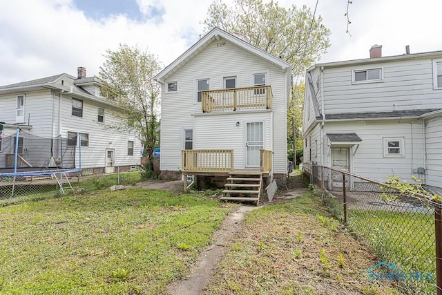 940 Kingston Ave, Toledo, OH 43605 - back of house with a trampoline, a balcony, and a wooden deck