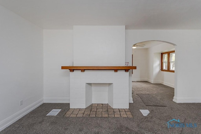 940 Kingston Ave, Toledo, OH 43605 - unfurnished living room with carpet, arched walkways, and baseboards