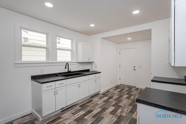 940 Kingston Ave, Toledo, OH 43605 - kitchen with a sink, dark countertops, white cabinetry, and recessed lighting