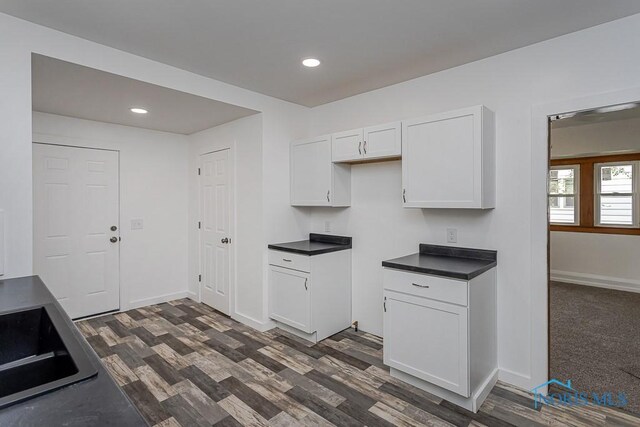 940 Kingston Ave, Toledo, OH 43605 - kitchen with dark countertops, white cabinets, recessed lighting, baseboards, and dark wood finished floors