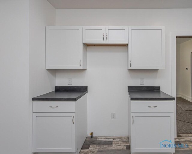 940 Kingston Ave, Toledo, OH 43605 - kitchen with dark countertops, white cabinets, and dark wood-style flooring