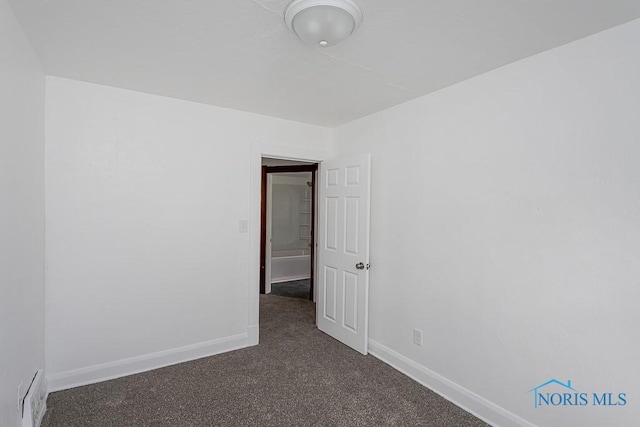 940 Kingston Ave, Toledo, OH 43605 - empty room with dark carpet and baseboards
