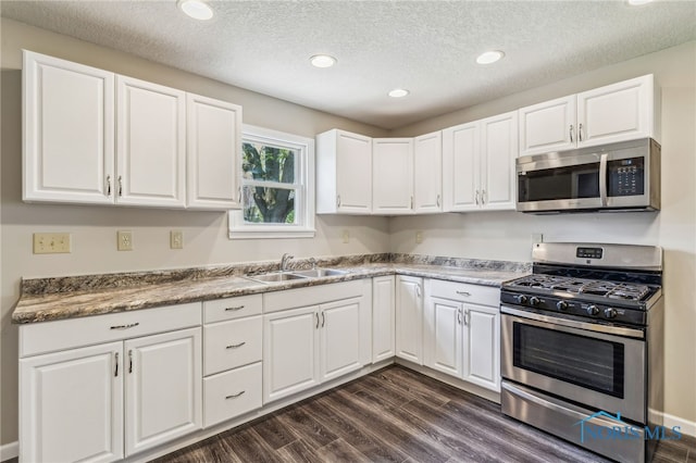 221 Poplar St, North Baltimore, OH 45872 - kitchen featuring appliances with stainless steel finishes, white cabinetry, a sink, a textured ceiling, and recessed lighting