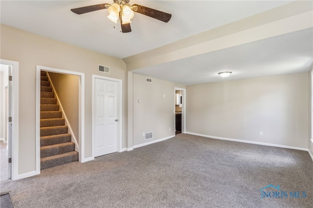 221 Poplar St, North Baltimore, OH 45872 - unfurnished living room with carpet floors, ceiling fan, stairway, and baseboards