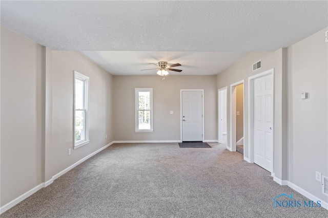 221 Poplar St, North Baltimore, OH 45872 - carpeted spare room with ceiling fan, baseboards, and a textured ceiling